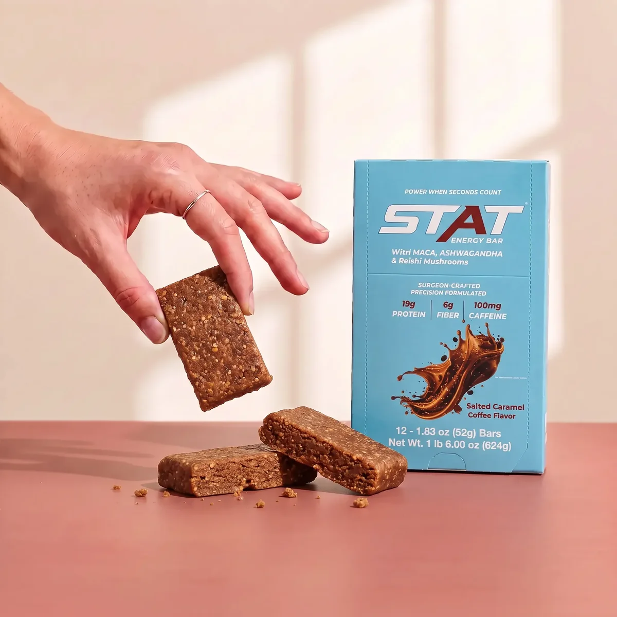 STAT Salted Caramel Coffee box with a bar held above it
